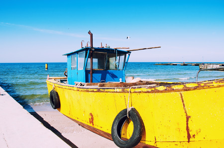 Old fishing boat moored on the beachの写真素材