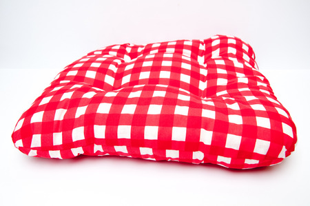 Red checkered pillow isolated on whiteの写真素材