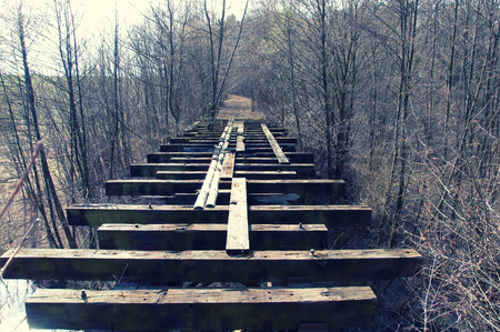 Old abandoned wooden bridge in forestの写真素材