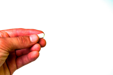 Hand holding medical pillの写真素材