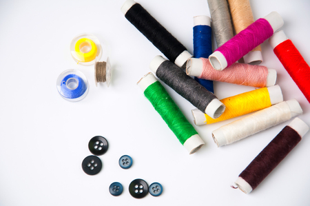 Sewing thread and buttons isolated on white backgroundの写真素材