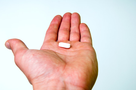 Hand holding medical pillの写真素材