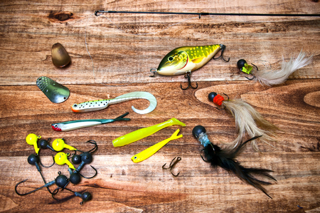 Fishing baits isolated on wooden backgroundの写真素材