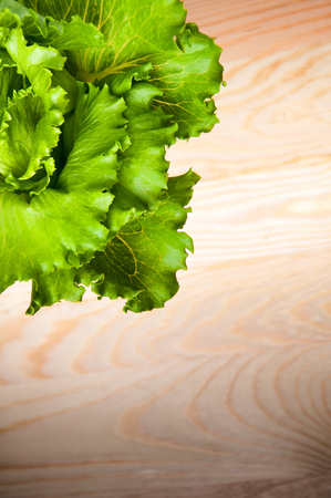 Lettuce salad isolated on a wooden backgroundの写真素材