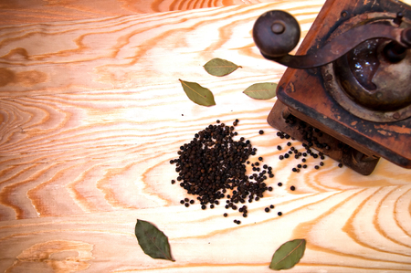 Vintage pepper mill and dried spices on wooden backgroundの写真素材