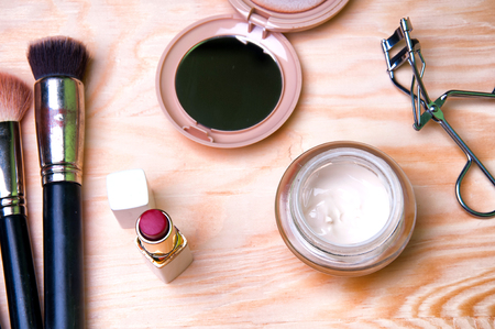Cosmetics and accessories on a wooden tableの写真素材