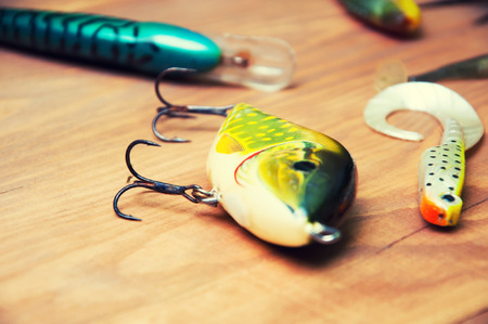Fishing baits isolated on wooden backgroundの写真素材