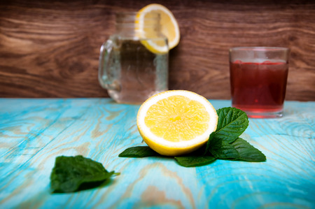Cold fresh drinks and ice cubes on wooden backgroundの写真素材