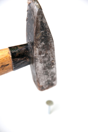 Studio isolated hammer hitting a nailの写真素材