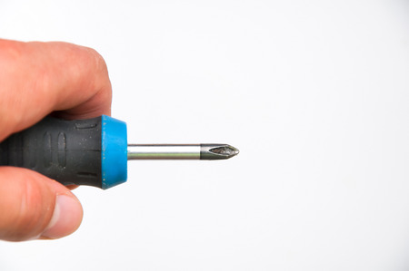 Screwdriver in hand isolated on whiteの写真素材