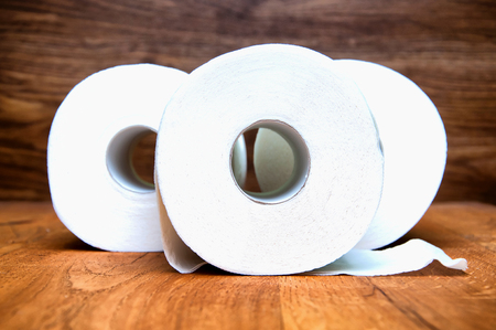 Toilet paper on wooden backgroundの写真素材