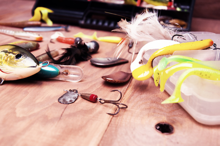 Fishing baits isolated on wooden backgroundの写真素材