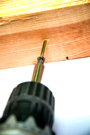 Wireless screwdriver screwing the screwの写真素材