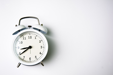 White alarm clock isolated on white backgroundの写真素材