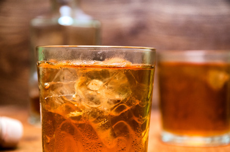 Glass of scotch whiskey on a wooden tableの写真素材