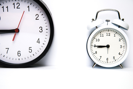 Two clocks isolated on white backgroundの写真素材