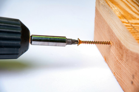 Wireless screwdriver screwing the screwの写真素材