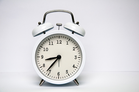 White alarm clock isolated on white backgroundの写真素材