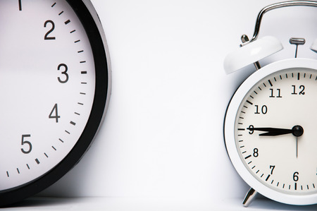 Two clocks isolated on white backgroundの写真素材