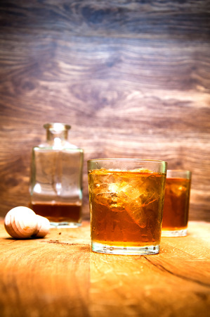 Glass of scotch whiskey on a wooden tableの写真素材