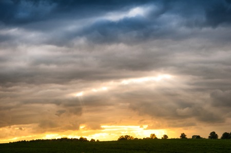 Dramatic sunset over fieldsの写真素材