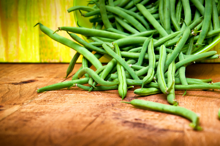 Fresh green beans on wooden tableの写真素材