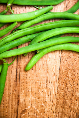 Fresh green beans on wooden tableの写真素材