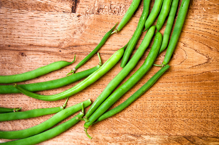 Fresh green beans on wooden table