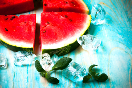 Pieces of watermelon on blue wooden backgroundの写真素材