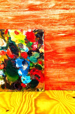 Painting palette on colored wooden background
