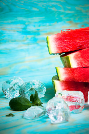 Pieces of watermelon on blue wooden backgroundの写真素材
