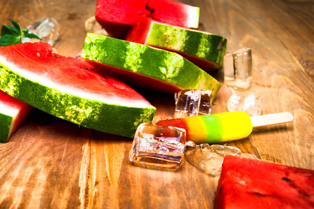 Pieces of watermelon and ice cream on wooden backgroundの写真素材