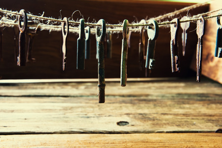 Old rusty keys hanging on a twineの写真素材