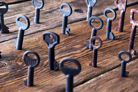 Old rusty keys on wooden backgroundの写真素材