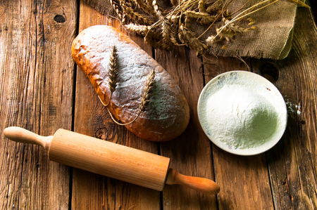 Homemade loaf of bread and ingredientsの写真素材