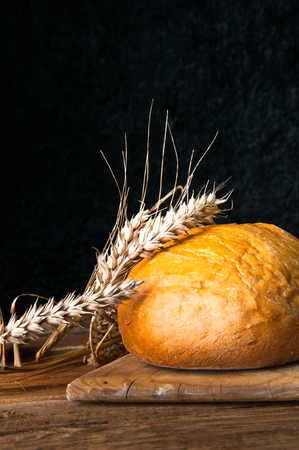 Homemade loaf of bread and wheatの写真素材