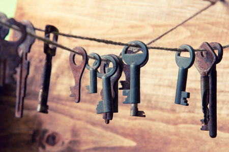 Old rusty keys hanging on a twineの写真素材