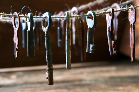 Old rusty keys hanging on a twineの写真素材