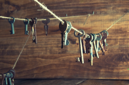 Old rusty keys hanging on a twine