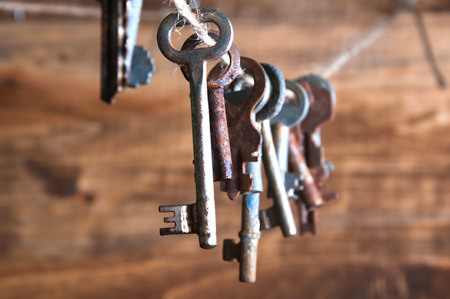 Old rusty keys hanging on a twineの写真素材