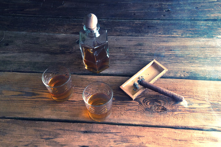 Whisky and cigar on wooden tableの写真素材