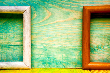 Old abstract picture frames on colored wooden backgroundの写真素材