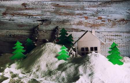 Handmade paper house and trees in winterの写真素材