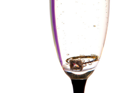 Engagement ring in a glass of champagneの写真素材