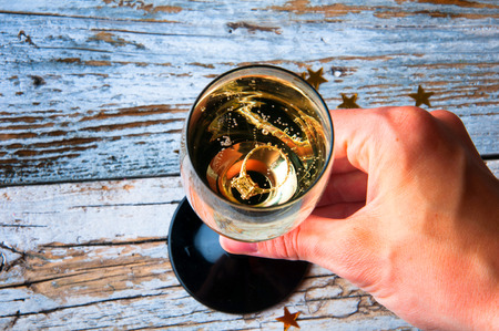 Engagement ring in a glass of champagne. View from aboveの写真素材