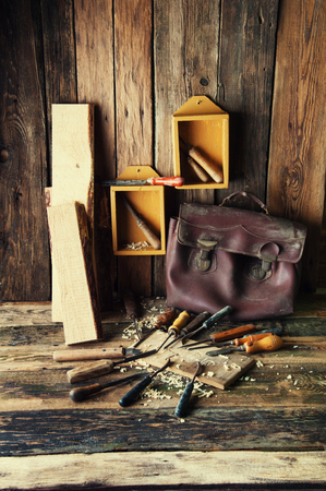 Chisels and carved piece of wood in traditional carpenter workshopの写真素材