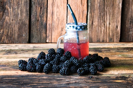 Delicious blackberry drink and fruits on wooden backgroundの写真素材