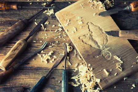 Chisels and carved piece of wood in traditional carpenter workshopの写真素材