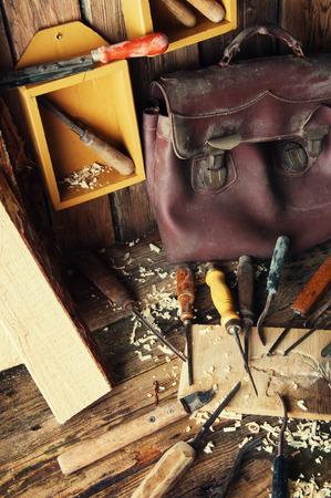 Chisels and carved piece of wood in traditional carpenter workshopの写真素材