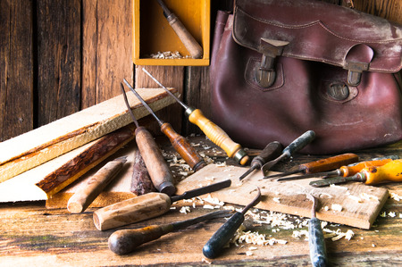 Chisels and carved piece of wood in traditional carpenter workshopの写真素材